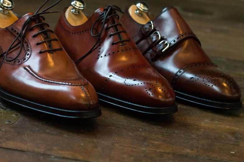 the three pairs of dress shoes are lined up