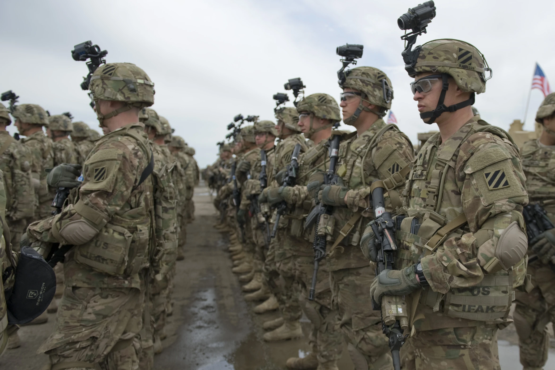 a group of soldiers stand together with their gear in hand