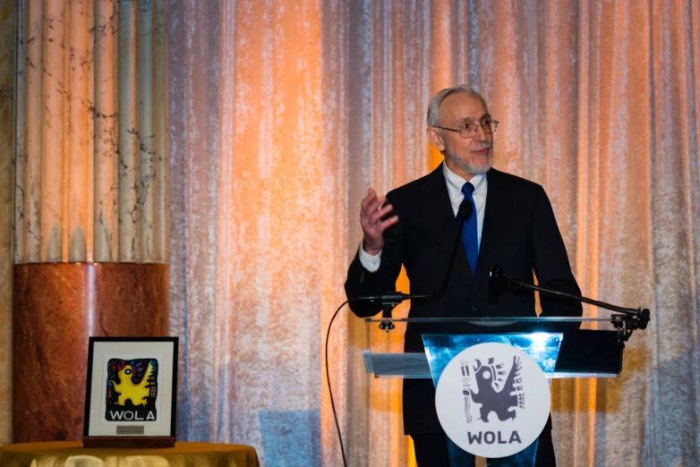 a man stands at the front of a podium