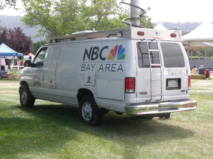 a white bank and bay area truck in the grass