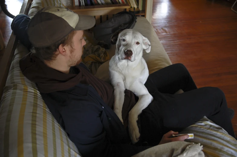 a man and a dog are sitting on the couch