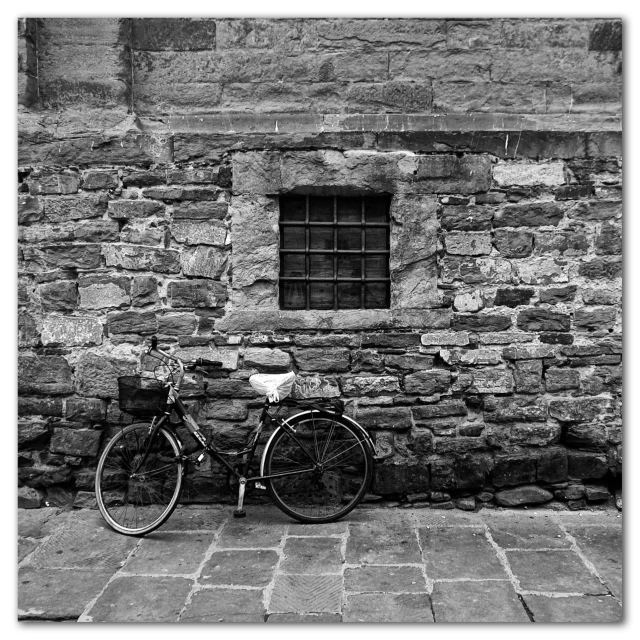 a bicycle parked outside a stone building