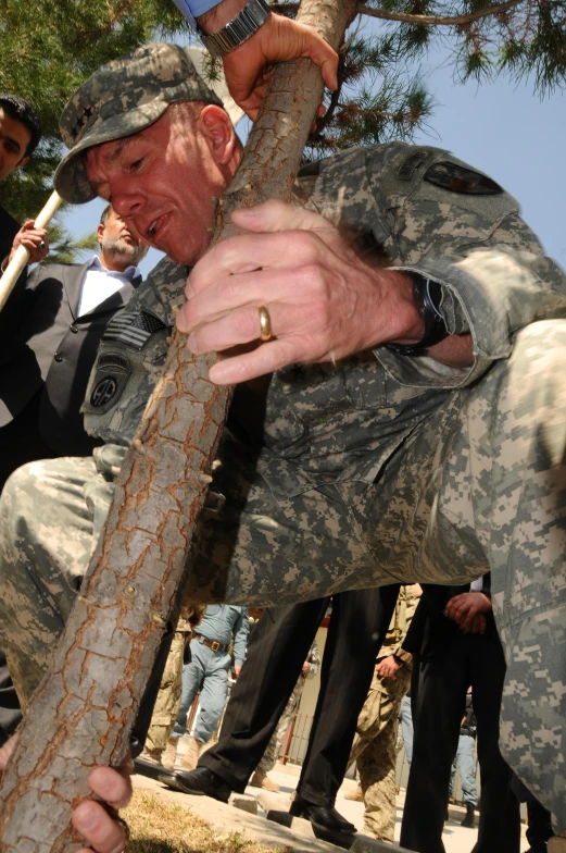 a man holding a large snake by the end of it