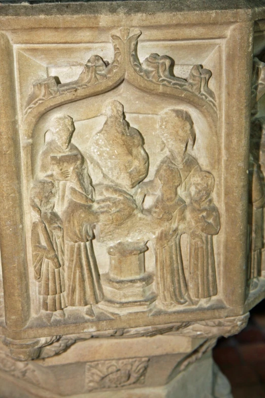 relief art depicting a family gathering in a temple