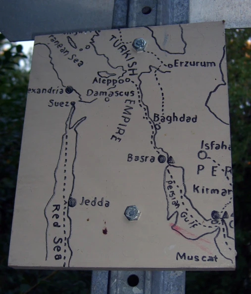 a map is posted on a pole in the wilderness