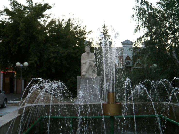 a water fountain with a small statue next to it