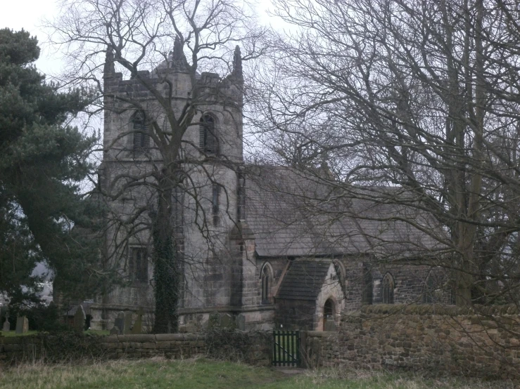 a large old church sits next to trees