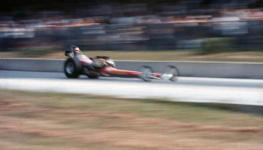 a racing car speeds down a winding track