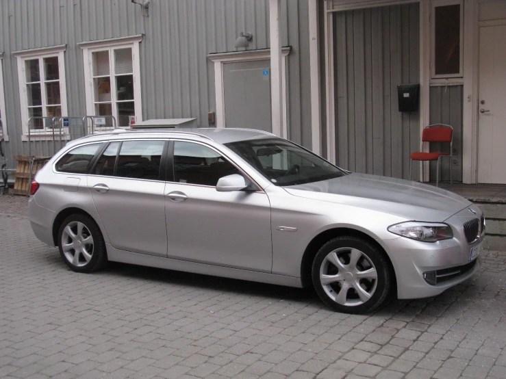 silver car parked in front of building next to door