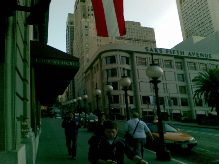 people walk down a street in the city