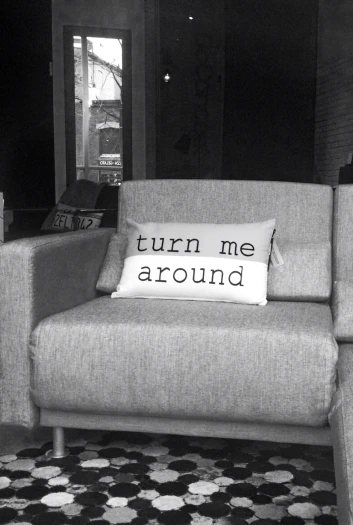a chair with a pillow that says turn me around