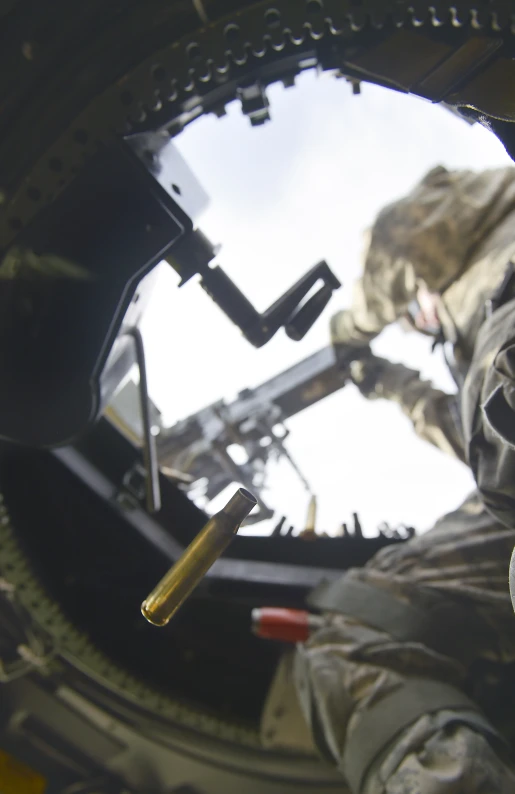 a man holding a rifle and wearing uniform