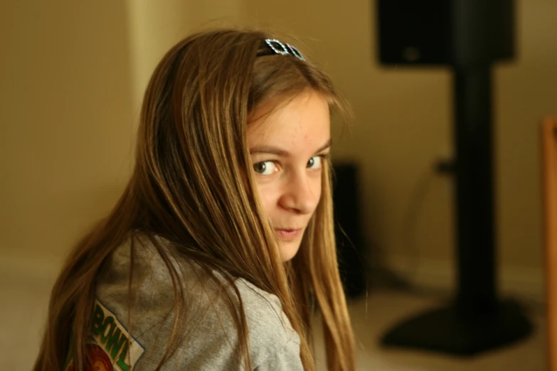 a girl with a pair of hair clips in front of her head