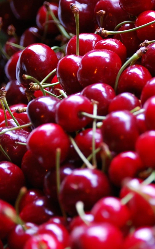 the red fruit is piled high on the table