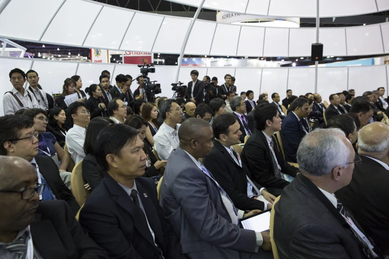 an audience at an event with people sitting