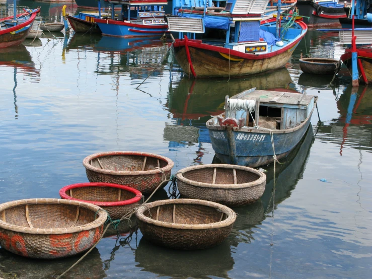 several boats sitting on the water beside each other