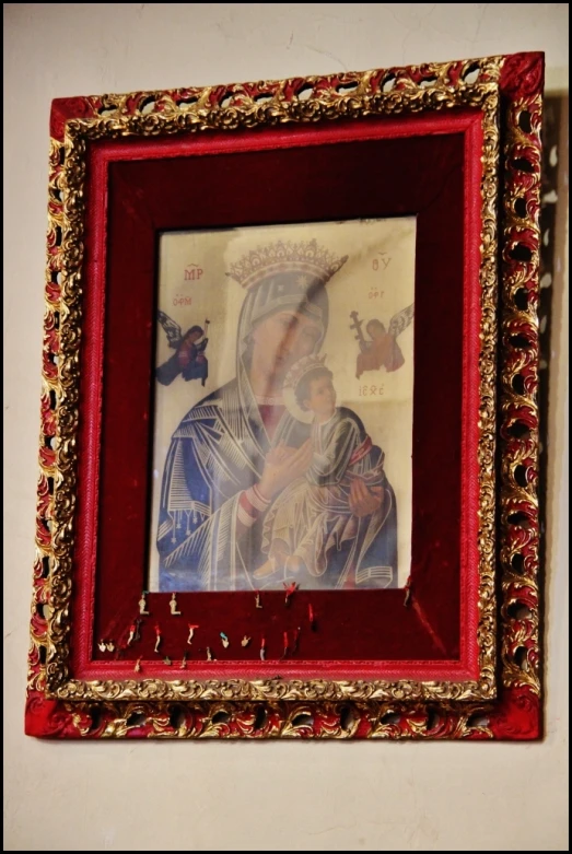 a portrait frame with gold edges, a picture of a mother and child