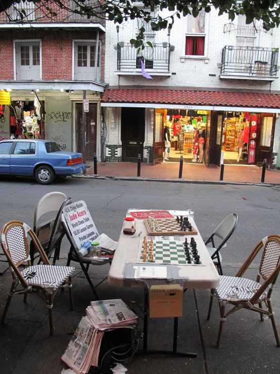 several pieces of chess set up at an outdoor table