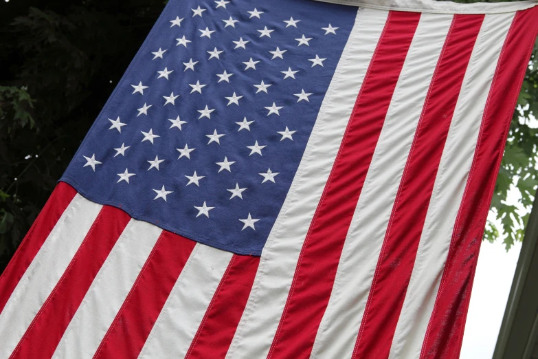 a large american flag hanging from a clothesline