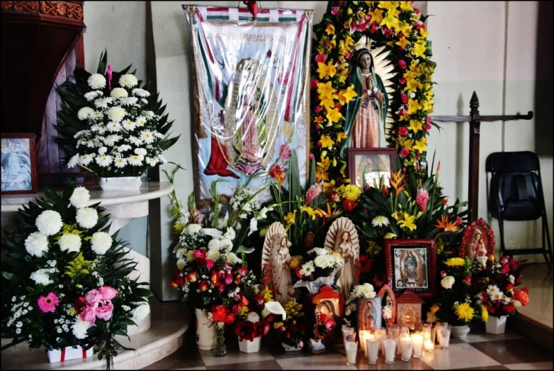 altar with flowers, candles and pictures of people on the wall