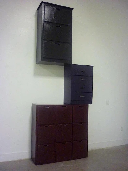 a brown dresser is seen in an empty room