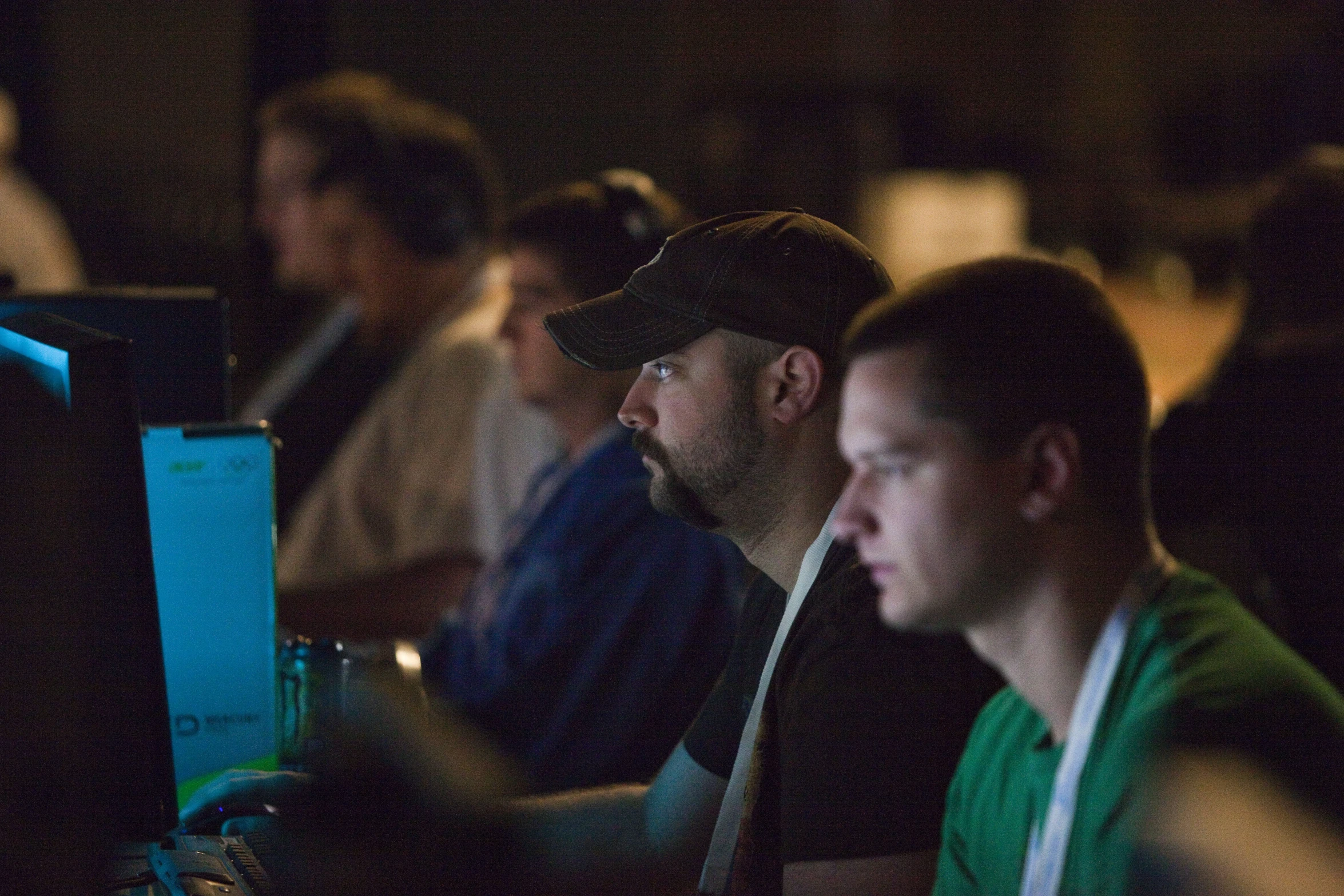 several people in front of computer screens