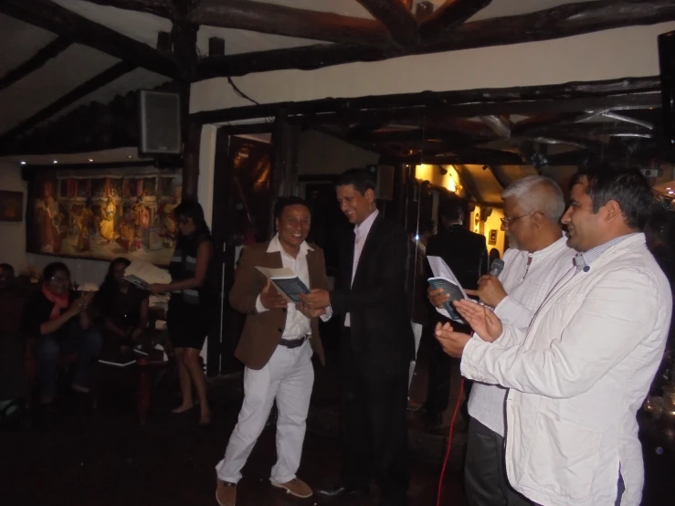 a bunch of men in business suits at a party