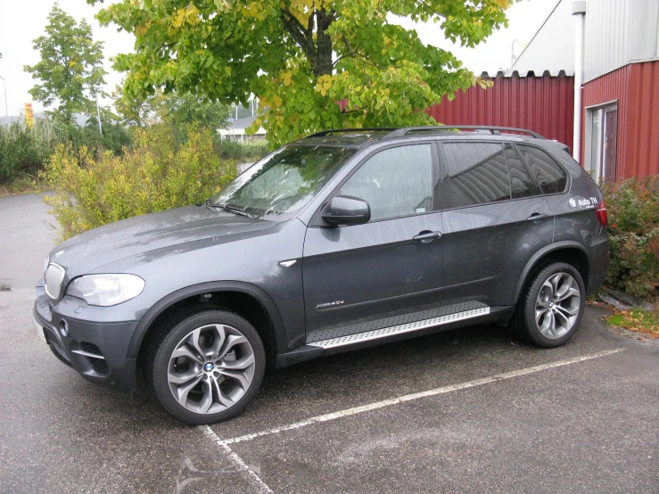 a car is parked in a lot with trees