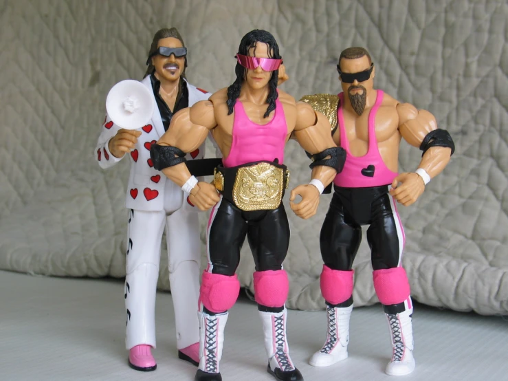 a group of action figures in pink and black outfits