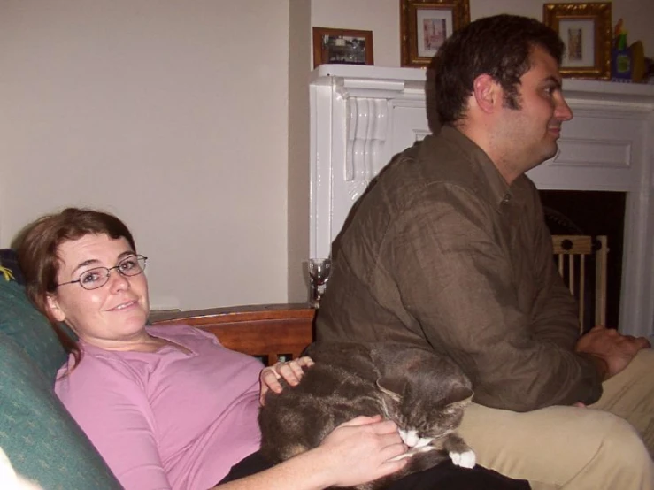 a woman sitting on a couch with her cat