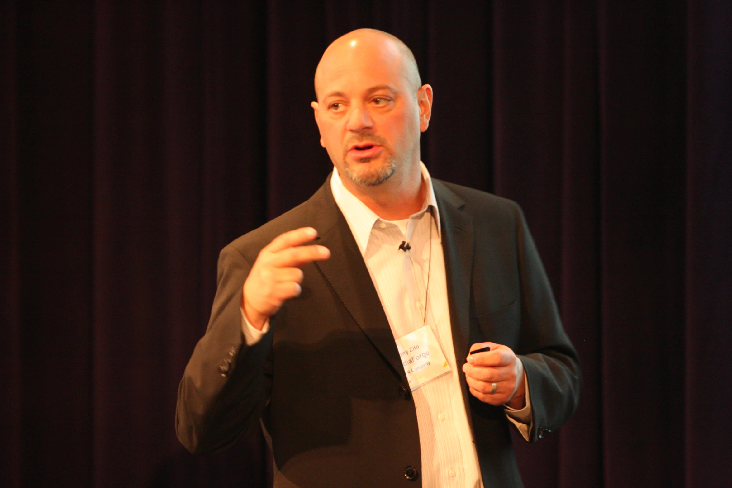 a man standing on stage giving a presentation