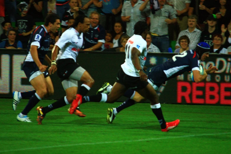 a group of players from two teams fighting for the ball