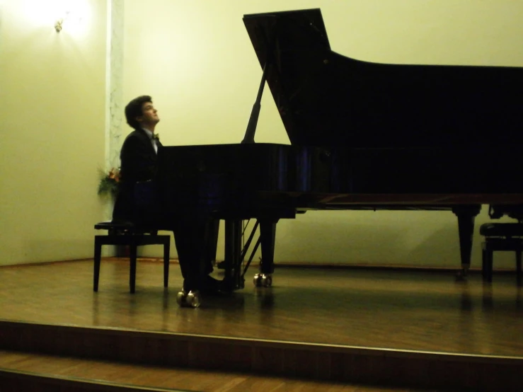 a man playing the piano on the stage