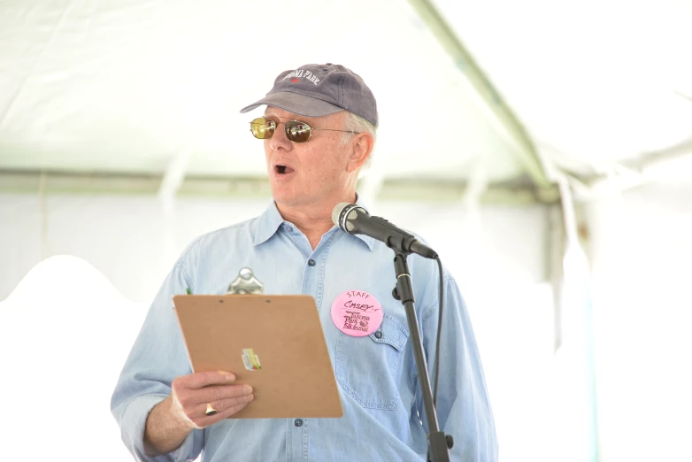 a man speaking from a podium at a microphone