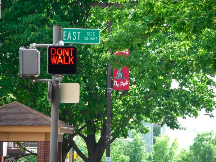 a cross walk sign with the words dont walk, no dogs and street signs above it