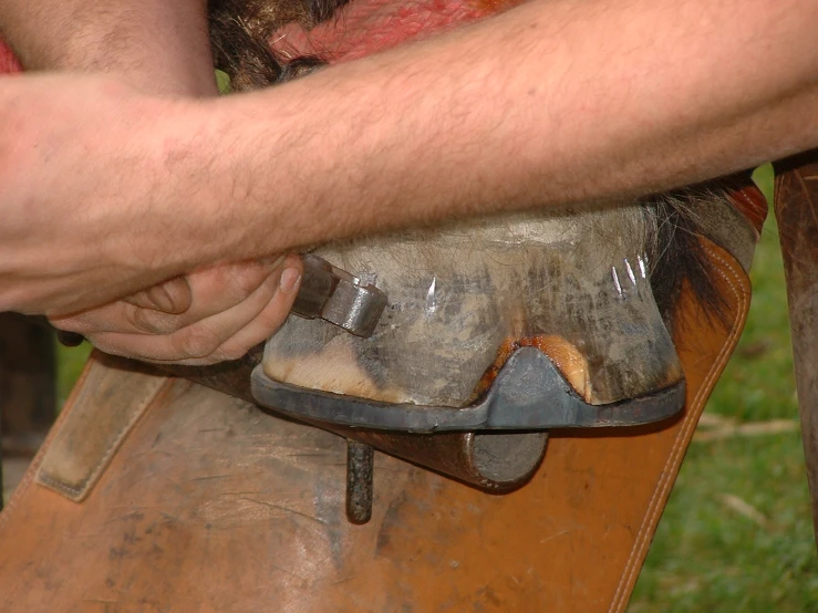 a wooden carving and the man is trying to fix it