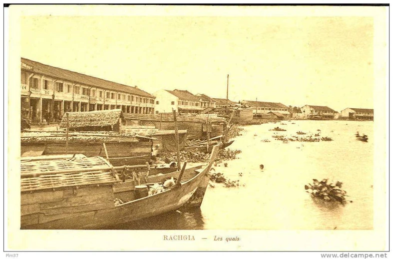 an old po shows the harbor and river side with several buildings
