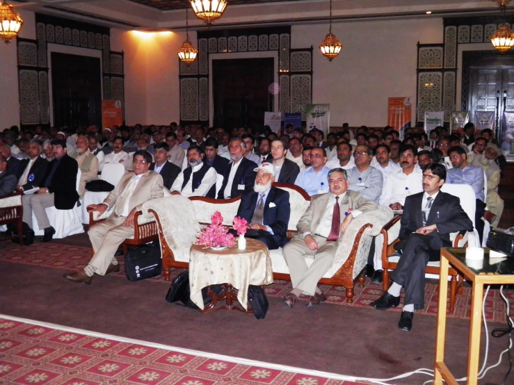 a group of men in suits sitting in front of each other