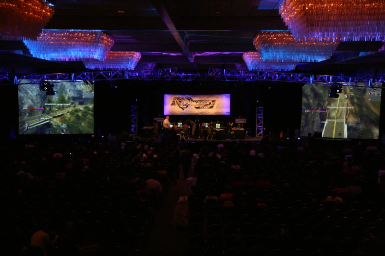 people are playing on the large screens at a convention