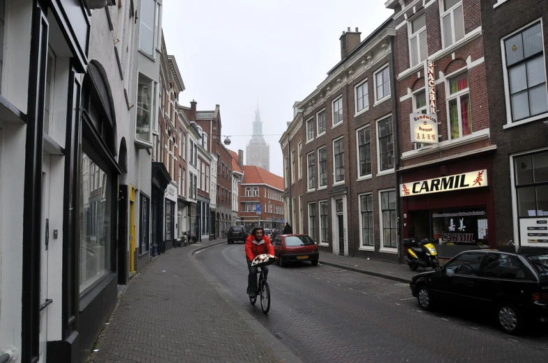 a man riding a bicycle down the side of a road