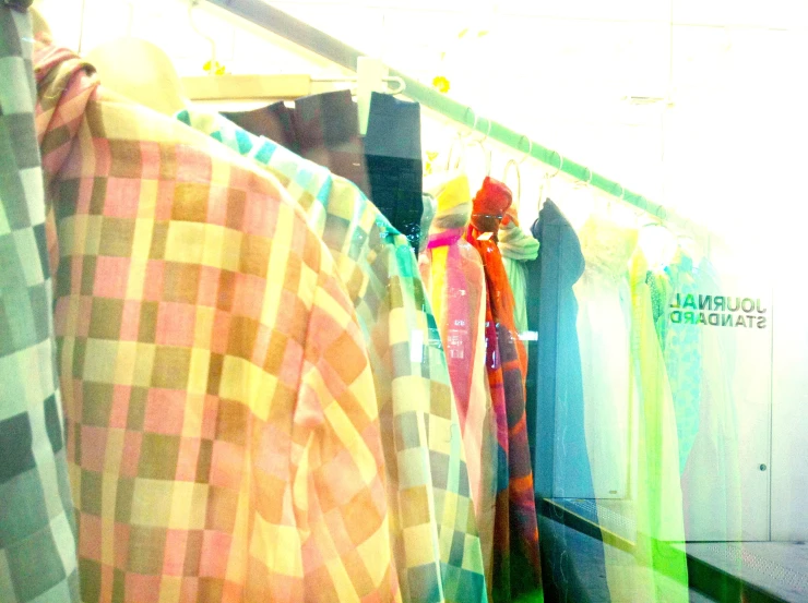 colorful shirts hanging up in a clothes closet