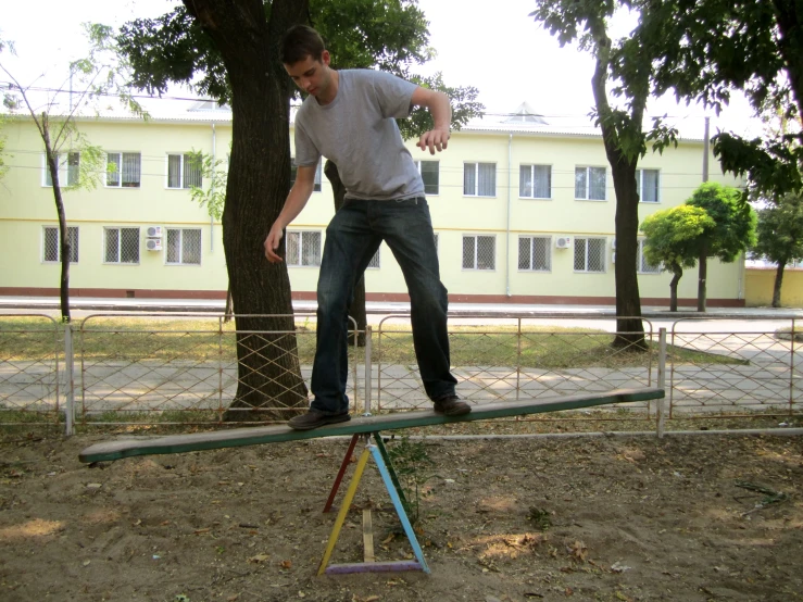 a man is balancing his skateboard on three small platforms