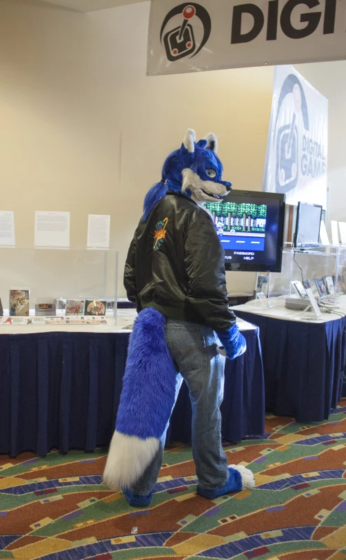 a person wearing a blue and white mascot holding a backpack