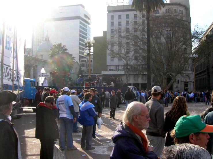 a group of people walking down a sidewalk