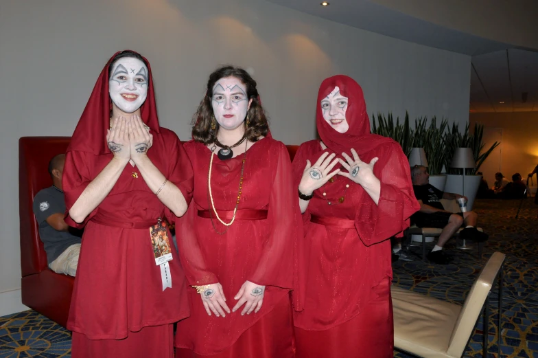 a group of women in red clothes pose for the camera