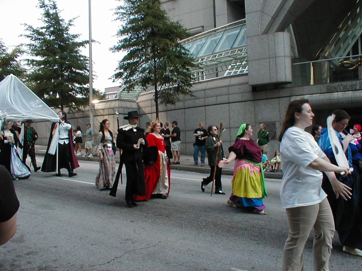 a group of people are walking on the street