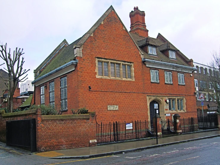 a brick building with a tall steeple in the middle of it