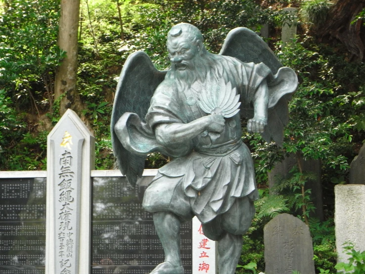 an image of an old sculpture of a man praying