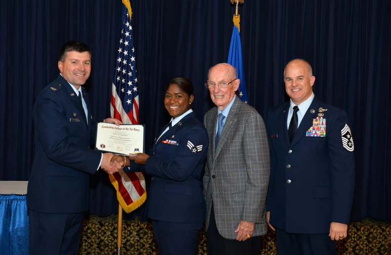 a group of people in uniforms holding an award plaque