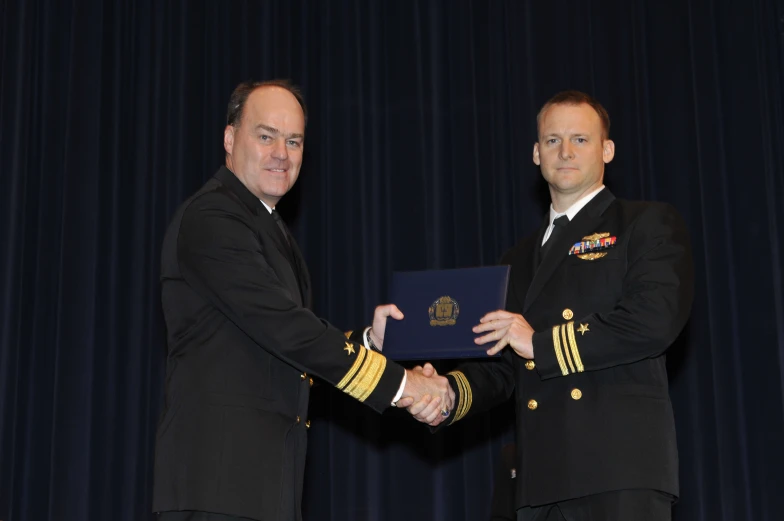 two men are shaking hands with an official seal